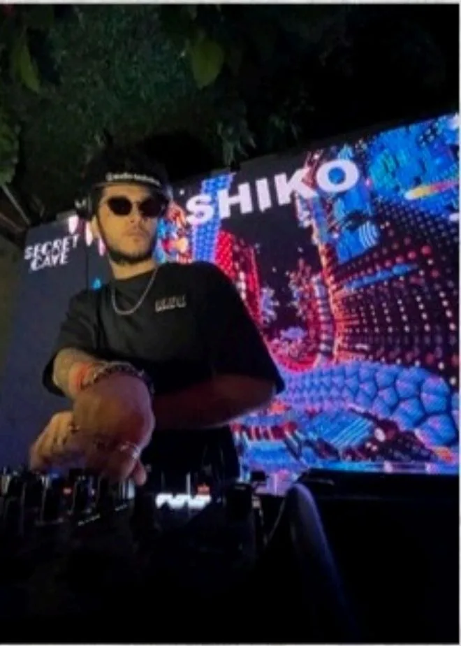 SHIKO performing in a red-lit room
